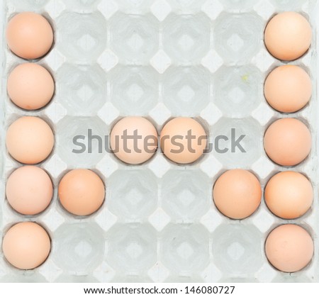 letter w  from the eggs,Eggs in paper tray isolated on white