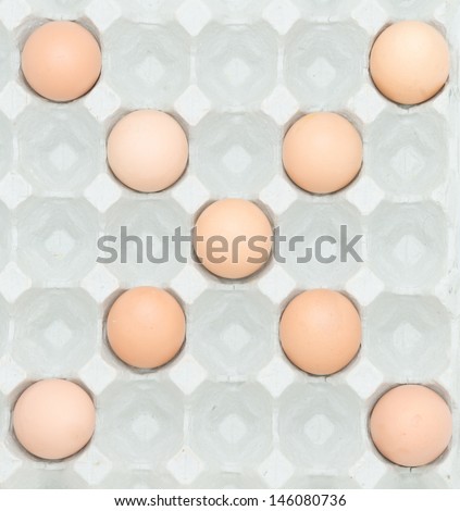 letter x  from the eggs,Eggs in paper tray isolated on white