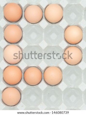 letter p  from the eggs,Eggs in paper tray isolated on white