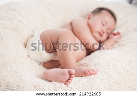 Close up of adorable baby sleeping. Isolated on white blanket. Dream come true
