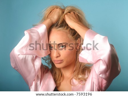 Woman in Silk Bathrobe running her fingers through her blond hair