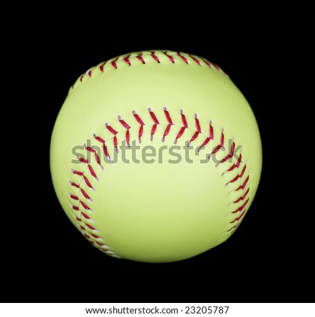 Yellow softball with red stitches isolated on black