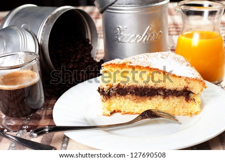 breakfast on the table with coffee, chocolate cake, orange juice and sugar