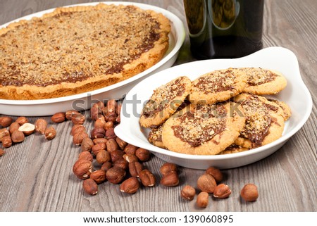 hazelnut and chocolate cookies and cake on the wood table