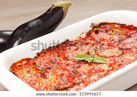 eggplants parmigiana traditional italian recipe on the wood table with oil