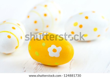 Yellow easter eggs on white wooden rustic background