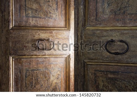 Old wooden door opening with light shining through