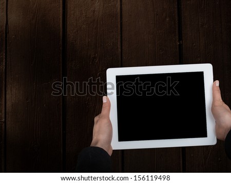 tablet in the hands of the old table