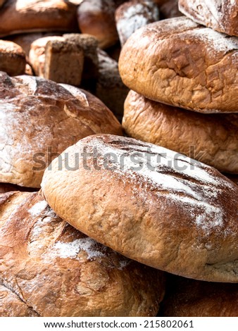 Big pile of freshly baked bread for sale on market