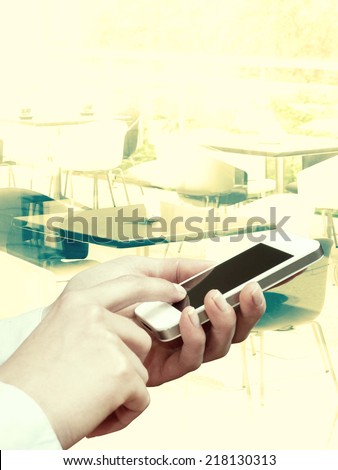 business woman using smartphone in the restaurant