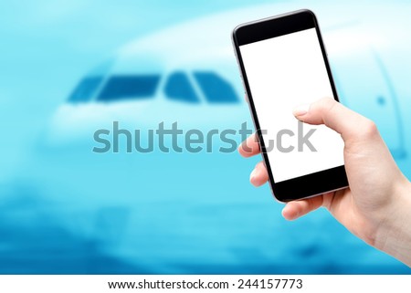 Mobile device in the hands of a woman on the background of aircraft cockpit