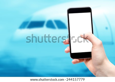 Mobile device in the hands of a woman on the background of aircraft cockpit