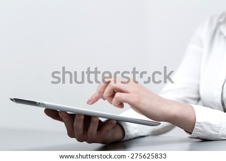 close up hands multitasking woman using tablet, around the blurred background