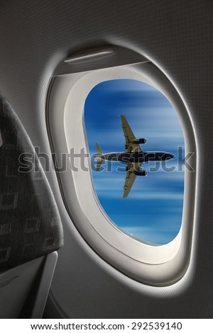 view from the airplane window onto another plane in flight