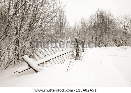 old fence on white snow