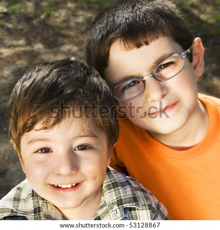 Happy brothers spending their time together outside. Focus mostly on younger brother.