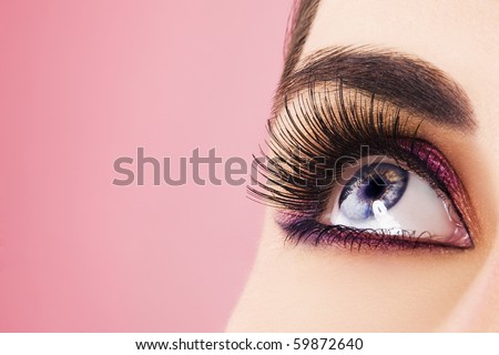 Woman eye with long eyelashes. Space for text.