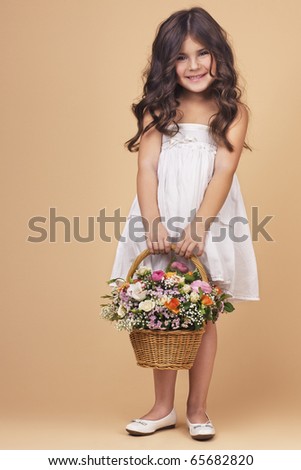 Charming girl with flower basket. Space for text.
