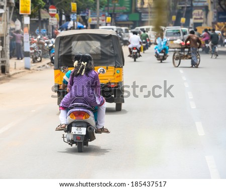 TRICHY, INDIA - FEBRUARY 15: An unidentified Indian riders ride motorbikes on rural road. India, Tamil Nadu, near Trichy. February 15, 2013