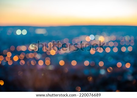 city blurring lights abstract circular bokeh on blue background with horizon, closeup