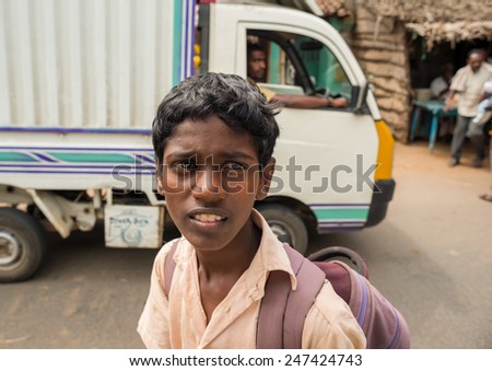 Thanjavur, India - February13: An unidentified student in uniform going home after classes at school. India, Tamil Nadu, near Thanjavur. February 13, 2013