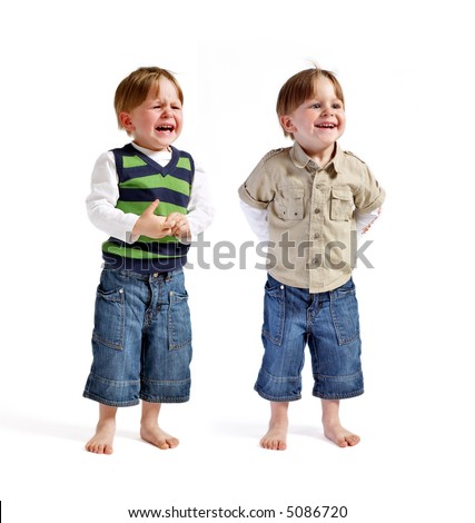 One face two emotions. Two very cute twin boys (smiling & crying) isolated on white background.