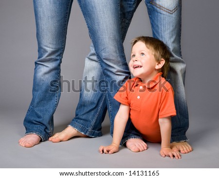 Studio shot of family of three wearing blue jeans