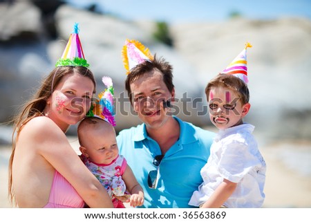 First birthday party. Young family with two kids on birthday party