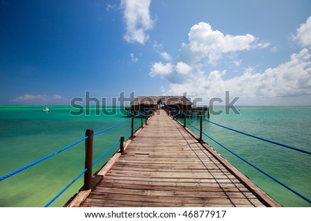 Wooden jetty and turquoise waters of tropical ocean
