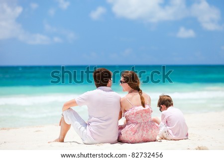 Back view of young family at Caribbean beach