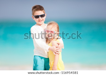 Happy brother and sister enjoying time at beach