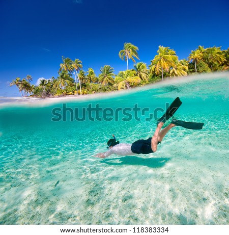 Man swimming underwater in a tropical lagoon