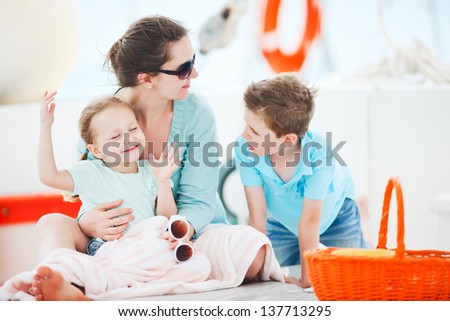 Mother and her kids having great time at luxury yacht