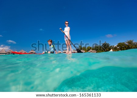 Mother and son paddle boarding together