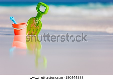 Colorful beach toys at beach in shallow water