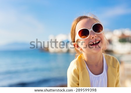 Cute little girl at Little Venice popular tourist area on Mykonos island, Greece