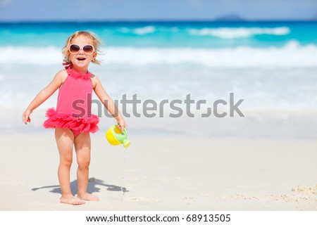 Similar – Image, Stock Photo Adorable toddler girl playing with beach on white sand beach