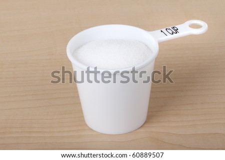 Measuring cup with one cup of sugar