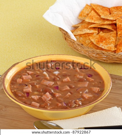 Bowl of ham and bean soup with tortilla chips