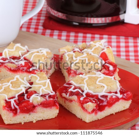 Four cherry bar cakes on a red platter