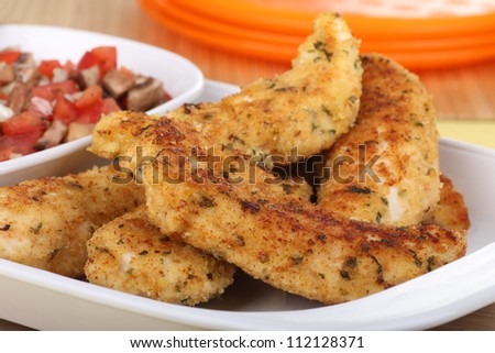 White platter of fried chicken breast tenderloins