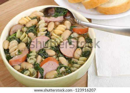 Sausage, spinach and bean soup in a bowl