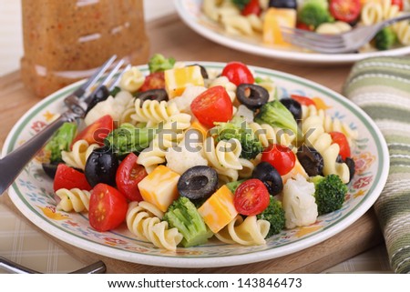 Pasta salad with tomato, broccoli, black olives, cauliflower and cheese