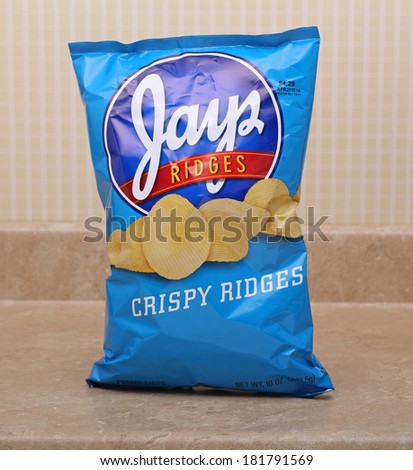 PETERSBURG, ILLINOIS-MARCH 9, 2014:  Bag of Jays potato chips on kitchen counter.  Jays is a subsidiary of Snyder\'s of Hanover operating in midwestern states of the USA.