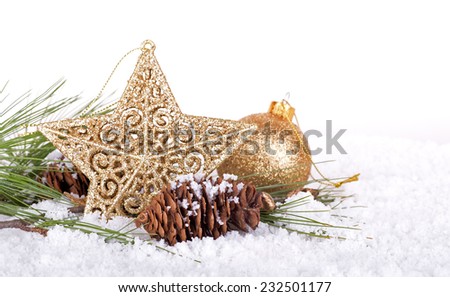 Shiny gold holiday star and pine cone in snow with white background