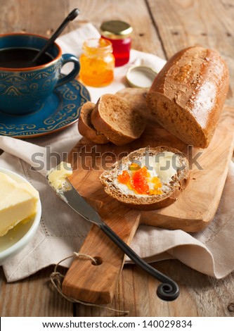 Breakfast with coffee, bread, butter and jam