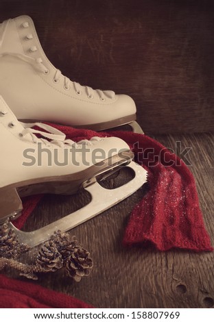 Skates for figure skating on a wooden background, toned