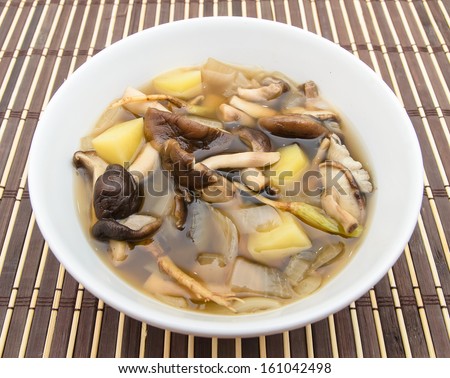 Shiitake mushroom soup with onion and potato on bamboo mat