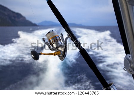 Fishing gear and fisherman boat sailing away in open sea