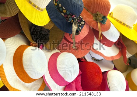 Beautiful colorful summer straw hats are line up